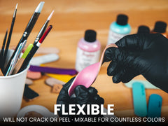Angelus paint being applied with a fine brush on a sneaker for precise customization