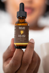 Black Girl Vitamins ingredient label close-up showing D3, K2 (MK-7), and omega-3 transparency