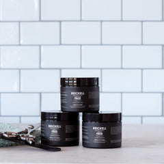 Brickell pomade open jar with visible clay ready to apply benefit