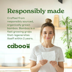 Caboo napkin in use on a kitchen table absorbing spill, fast cleanup benefit