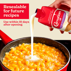 Carnation poured into mac and cheese illustrating creamier, richer dish