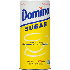 Domino pouring sugar into measuring spoon for accurate baking results