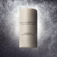Donna Karan Cashmere Mist stick held in hand to show compact travel size