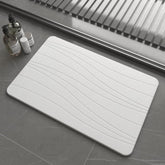 Drvykkn front view of white stone bath mat showing clean design and quick-dry benefit