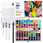 Grabie open metal case showing 100 color pans and organized layout for travel convenience