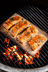Stack of Grill Gourmet planks next to ruler showing 5.5 by 11 inch dimensions