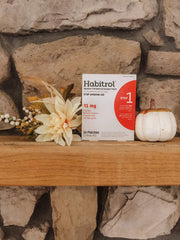 Person applying Habitrol patch to upper arm for all-day nicotine control