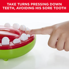 Hasbro Crocodile Dentist mid-press action capturing a tooth being pushed