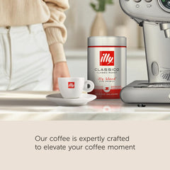 illy pouring grounds into portafilter for consistent extraction benefit