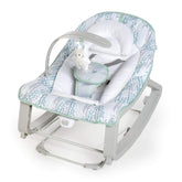Ingenuity front view of Keep Cozy bouncer showing spruce color and compact design benefits