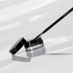 Inglot brush stroke of gel on white showing intense black pigment payoff