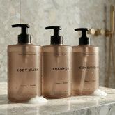 KIBAGA front view of three labeled dispensers for tidy shower storage