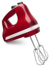 KitchenAid hand mixer front view showing Empire Red finish and ergonomic grip benefit