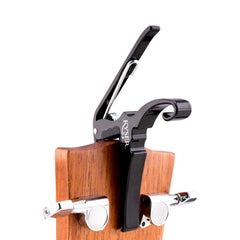 Kyser capo parked on headstock keeping guitar organized and ready