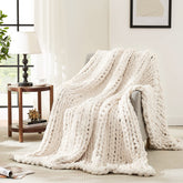 L'AGRATY ivory throw on sofa adds cozy texture and visual warmth