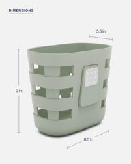 Lalo on bathtub rim with toys showing one-lift cleanup benefit