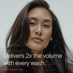 Living Proof full shampoo held in hand to show 8 oz scale and usability
