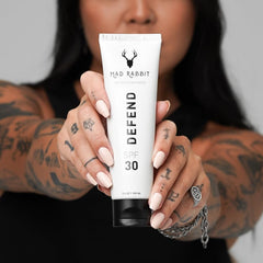 Mad Rabbit Defend application on tattooed arm demonstrating non-greasy coverage