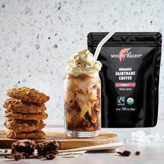 Spoon measuring Mount Hagen instant coffee into a mug for quick brewing