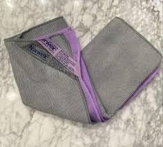 Norwex Window Cloth polishing a mirror for streak-free shine
