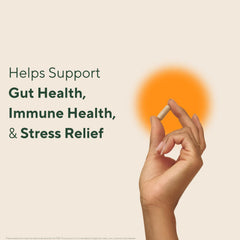 OM MUSHROOM SUPERFOOD three capsules by a glass of water illustrating daily dose convenience