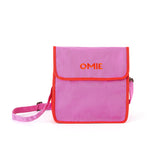 Omie pink lunch bag front view showing compact fit and handle