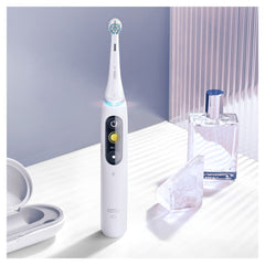 Oral-B brush head attached to iO handle demonstrating secure click-on fit