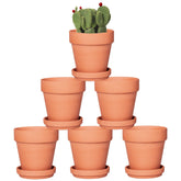 Orceler front view of six 4-inch terracotta pots with saucers showing natural finish and shape benefit