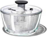 OXO glass salad spinner front view showing elegant serving bowl and stability