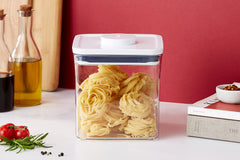 OXO lid close-up with push-button seal visible, easy airtight sealing benefit
