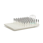 OXO Tot front view drying rack showing organized bottles and tidy countertop benefit