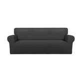 PureFit front view on large sofa showing full coverage and refreshed look