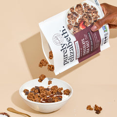 purely elizabeth granola served in a bowl with milk, demonstrates easy breakfast and satiety benefit