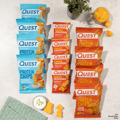 Hand holding Quest Nacho Cheese tortilla chip demonstrating portion size
