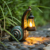 QZJDDZSW front view of snail statue showing decorative silhouette and ambient lighting