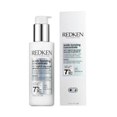 Redken bottle front view showing product design and restorative benefit