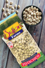 Setton Farms pistachios in a bowl beside snacks showing shareable serving