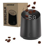 Subminimal front view showing matte black dosing cup and compact scale benefits counter space
