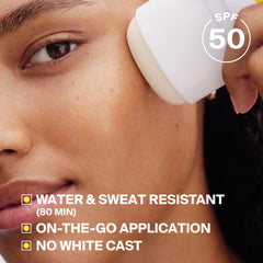 Supergoop! sunscreen stick held in hand to show scale and portable convenience