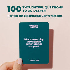 Couple using Talking Hearts cards at a candlelit table, brand encourages playful conversation