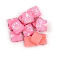Scattered pink Starburst chews from THE HAMPTON CANDY COMPANY showing consistent strawberry color and texture