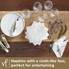 Vanity Fair unfolded napkin beside a plate illustrating 17 by 15 inch size for full coverage