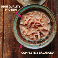 Wellness opened pouch top view with gravy to entice picky small dogs