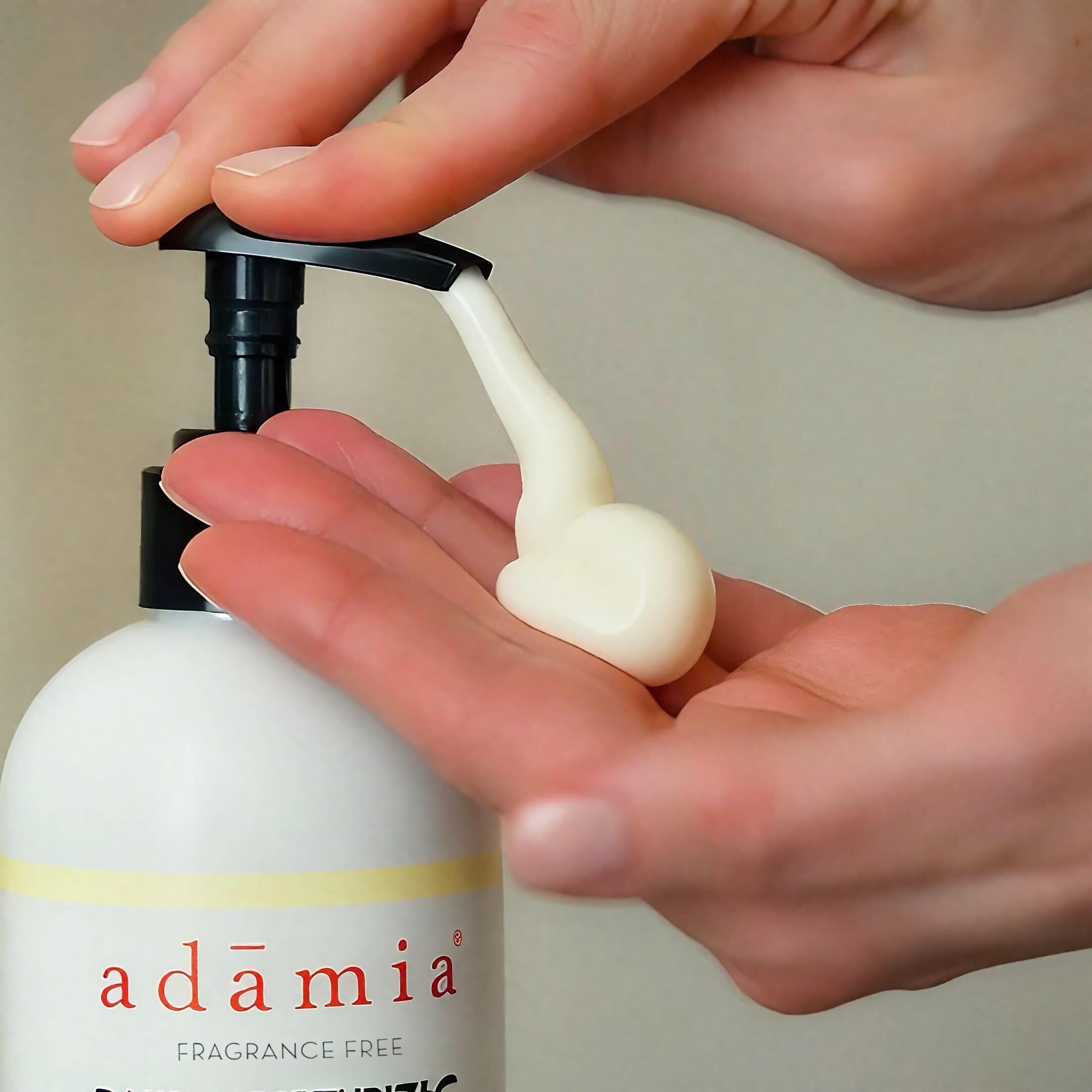 Adamia bottle beside hand to show 15oz scale and value