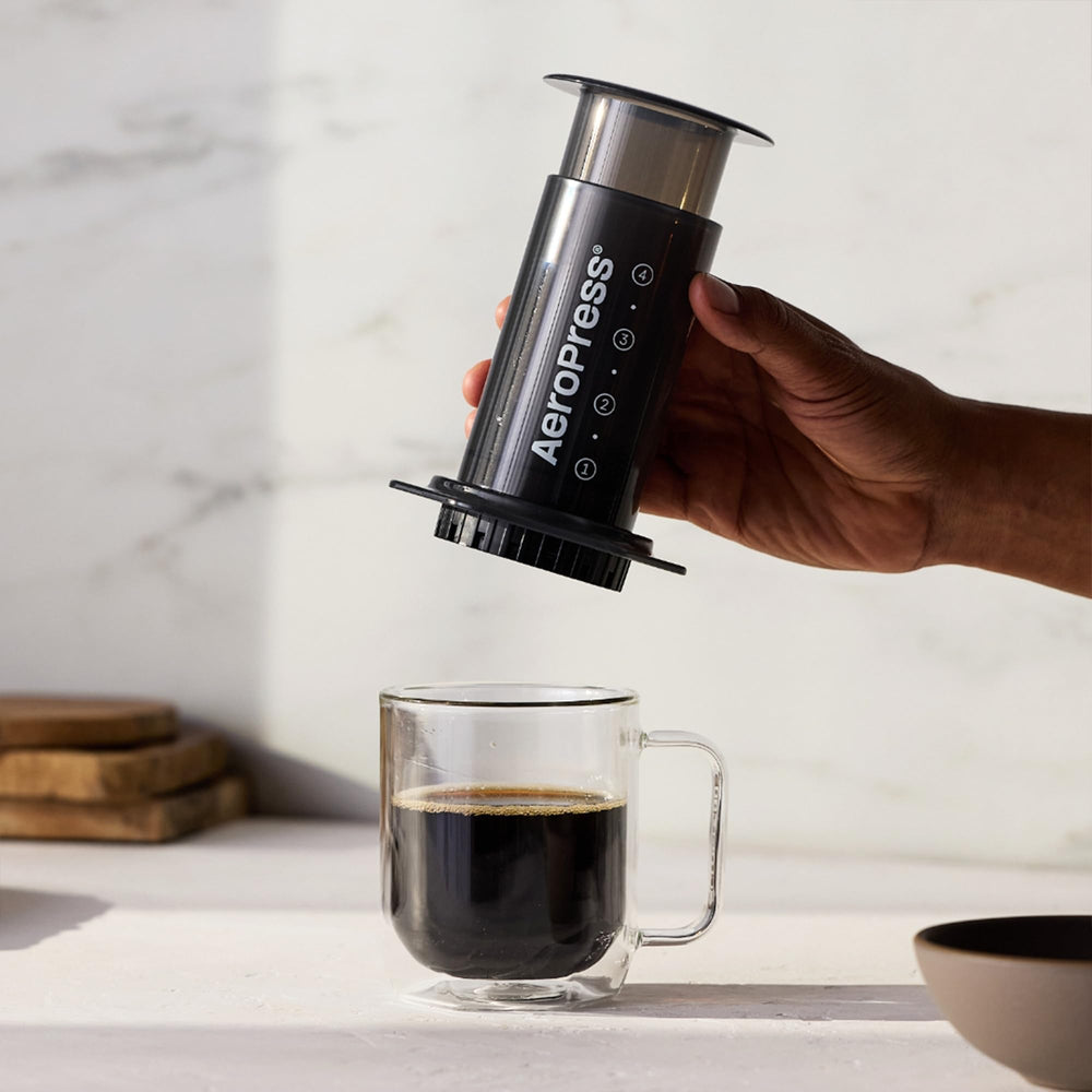 AeroPress beside cup showing scale and single-serve convenience benefit