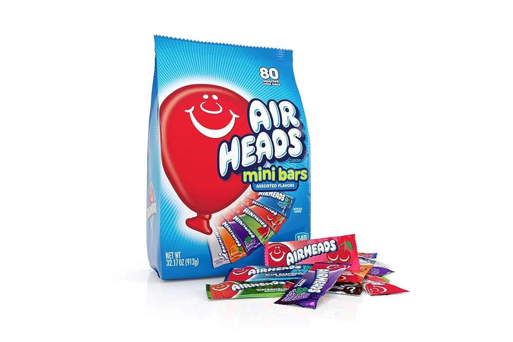 Hand holding Airheads mini bar to show actual size and convenient single-serve portion