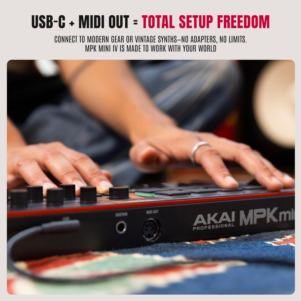 Akai Professional MPK Mini IV connected to a laptop for mobile music production on the go