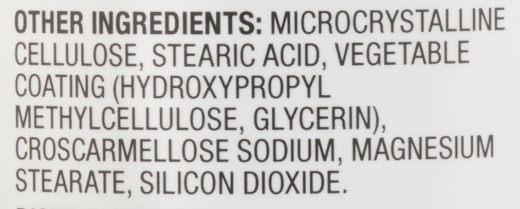 Amazon Basics bottle on a kitchen counter next to a glass of water illustrating convenient daily supplement use