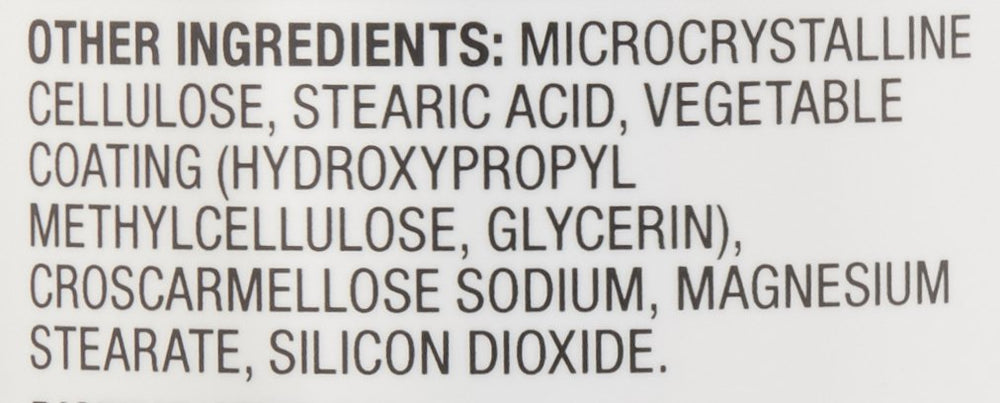 Amazon Basics bottle on a kitchen counter next to a glass of water illustrating convenient daily supplement use