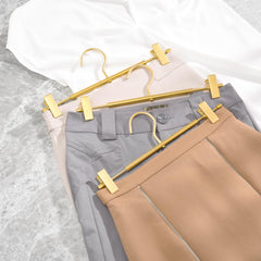 Amber Home hanger holding trousers in closet saving space and preventing wrinkles